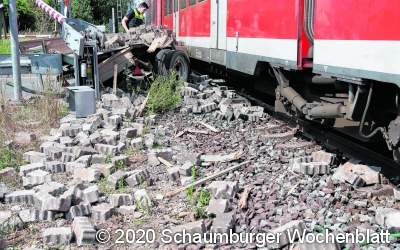 S-Bahn rauscht an Bahnübergang
in beladenen Trecker-Anhänger