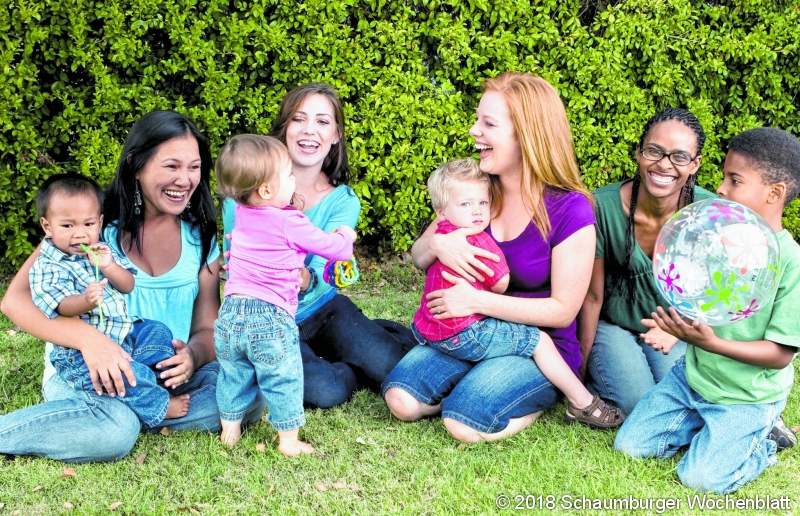 Group of mothers and thier children playing.