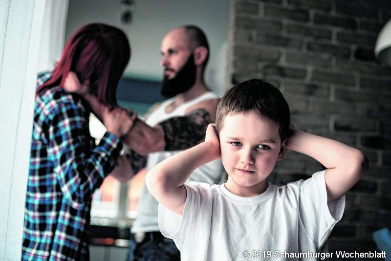 Sad, desperate little boy during parents quarrel. Clog the ears.